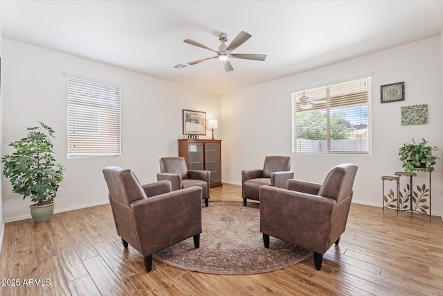 10417 W Alyssa Ln, Peoria, AZ 85383 - living area featuring wood-type flooring, visible vents, baseboards, and a ceiling fan