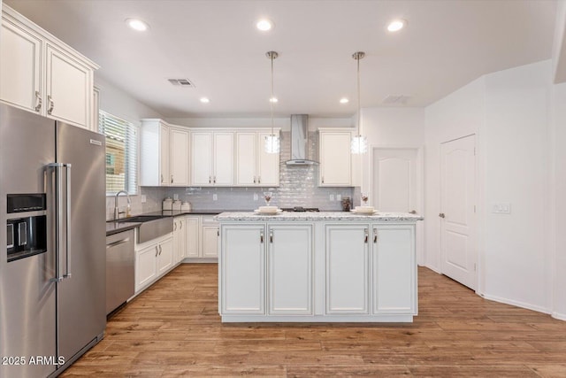 10417 W Alyssa Ln, Peoria, AZ 85383 - kitchen featuring wall chimney exhaust hood, white cabinets, visible vents, a sink, and stainless steel appliances