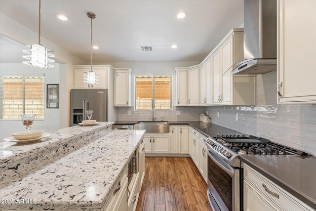 10417 W Alyssa Ln, Peoria, AZ 85383 - kitchen with light wood-style flooring, wall chimney range hood, visible vents, appliances with stainless steel finishes, and a sink