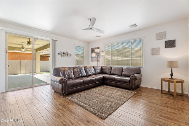 10417 W Alyssa Ln, Peoria, AZ 85383 - living area featuring wood finished floors, ceiling fan, baseboards, and visible vents