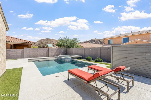 10417 W Alyssa Ln, Peoria, AZ 85383 - view of pool with a mountain view, a patio, a fenced backyard, and a pool with connected hot tub