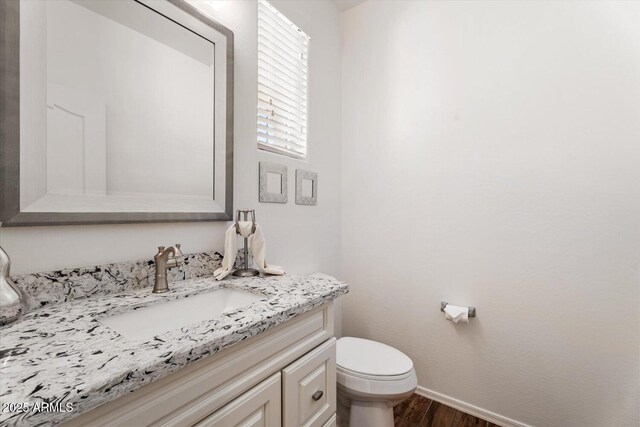 10417 W Alyssa Ln, Peoria, AZ 85383 - bathroom with toilet, baseboards, vanity, and wood finished floors