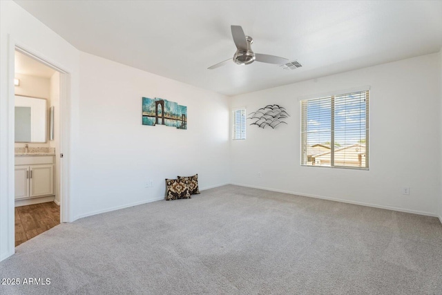 10417 W Alyssa Ln, Peoria, AZ 85383 - unfurnished room with baseboards, a ceiling fan, carpet floors, visible vents, and a sink