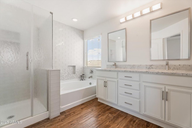 10417 W Alyssa Ln, Peoria, AZ 85383 - bathroom featuring a bath, a sink, a stall shower, and wood finished floors