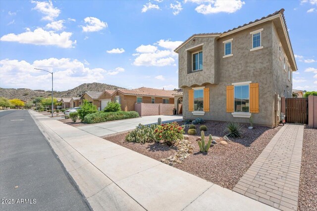 10417 W Alyssa Ln, Peoria, AZ 85383 - view of front of home featuring a mountain view, stucco siding, fence, and a gate