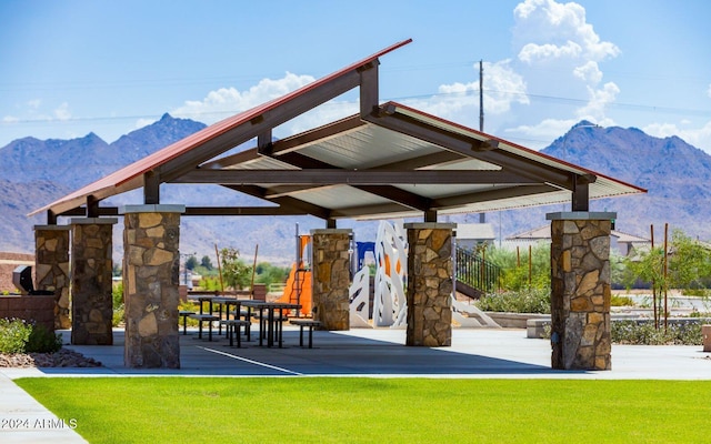 surrounding community with a gazebo, a mountain view, and a yard