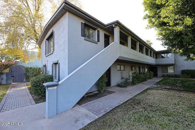 4224 N 12th St Unit 108, Phoenix, AZ 85014 - view of side of property with a gate and stucco siding