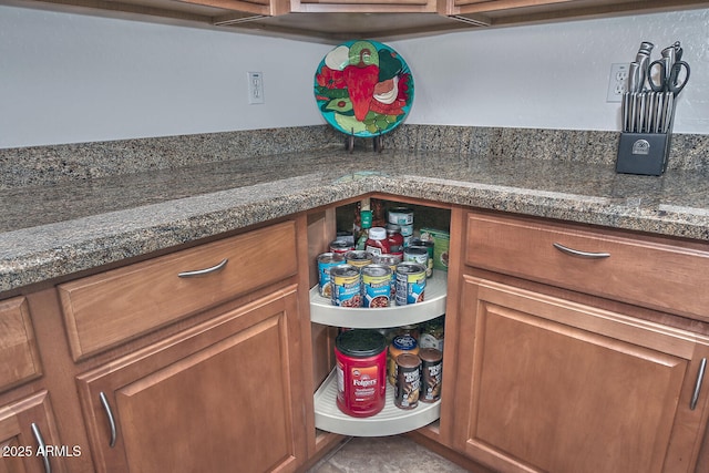 interior space with bar area and dark stone counters