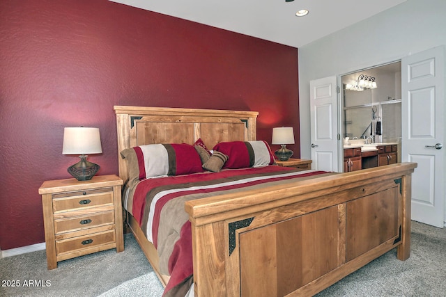 bedroom with light carpet and ensuite bathroom