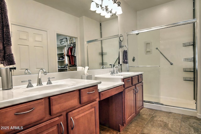 bathroom featuring vanity, an inviting chandelier, and walk in shower