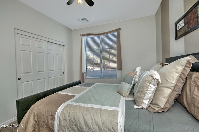 bedroom with ceiling fan and a closet