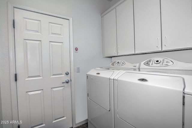 washroom with washing machine and dryer and cabinets