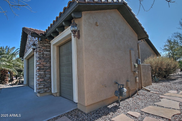 view of side of home with a garage