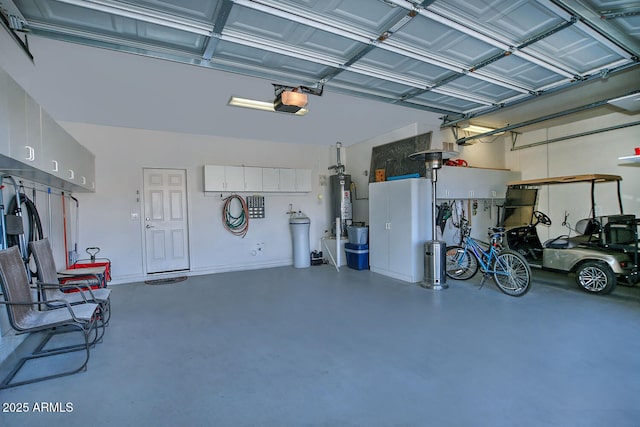 garage featuring a garage door opener and water heater