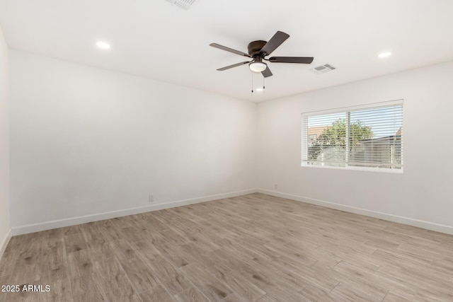unfurnished room with a ceiling fan, visible vents, light wood-type flooring, baseboards, and recessed lighting