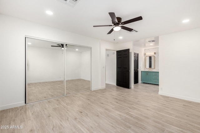 unfurnished bedroom featuring light wood-type flooring, recessed lighting, visible vents, and a closet
