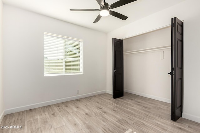 unfurnished bedroom with baseboards, a ceiling fan, light wood finished floors, and a closet