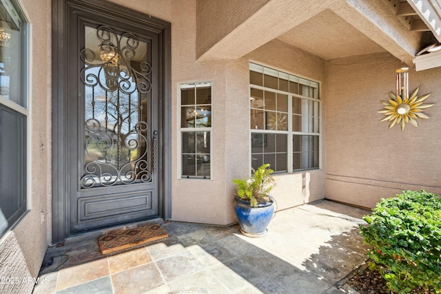 doorway to property with stucco siding