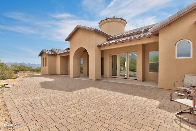 rear view of property featuring french doors and a patio