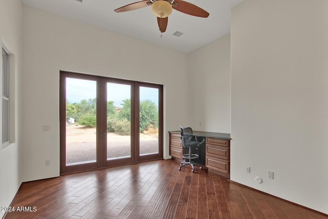 office space featuring ceiling fan, dark wood-type flooring, and a high ceiling