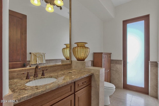 bathroom featuring vanity, tile floors, and toilet