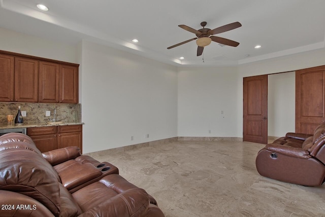 living room with light tile floors, ceiling fan, and sink