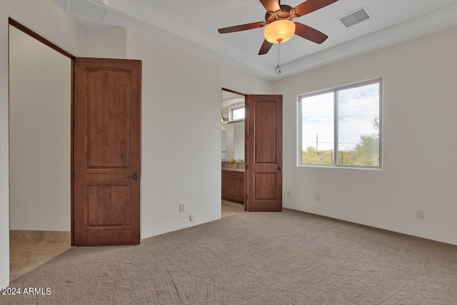 unfurnished bedroom with light carpet and ceiling fan