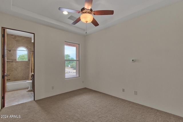 spare room featuring ceiling fan and light carpet