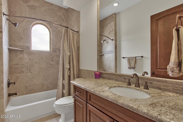 full bathroom with toilet, vanity, and shower / tub combo with curtain