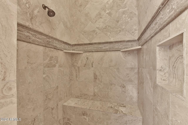 interior details with a tile shower