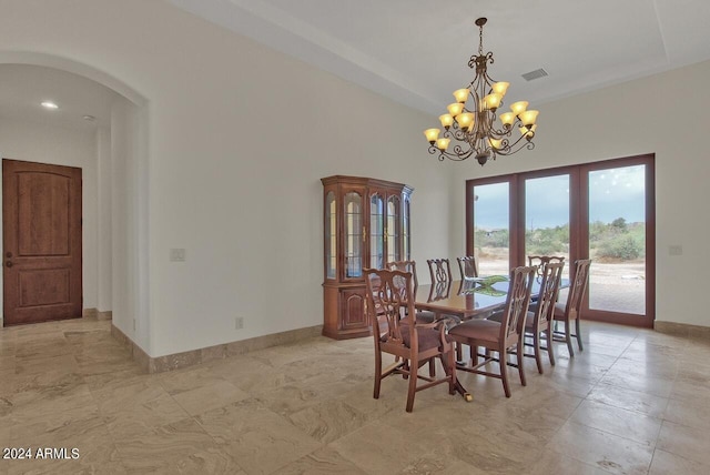 tiled dining space featuring a chandelier