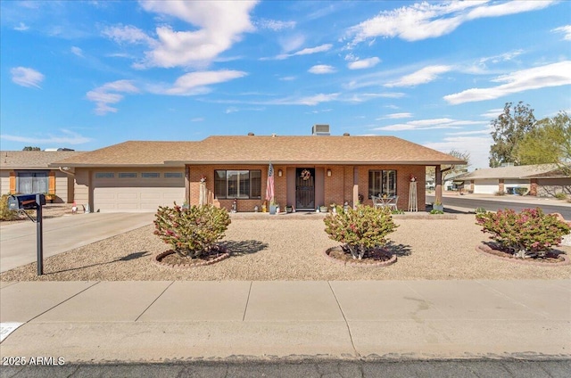 single story home featuring a garage, driveway, a porch, and brick siding