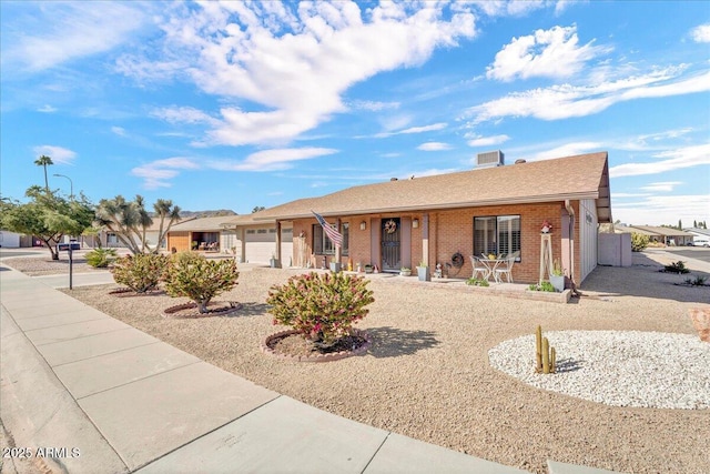 ranch-style house featuring an attached garage and brick siding