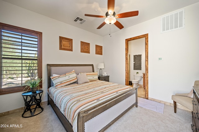 carpeted bedroom featuring ceiling fan and ensuite bathroom