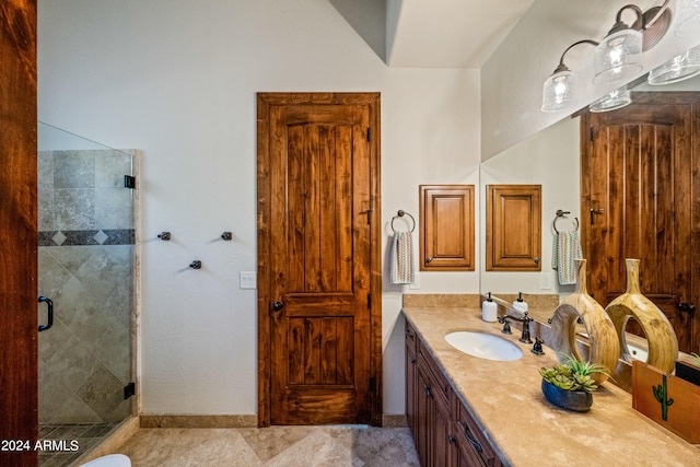 bathroom with walk in shower and vanity