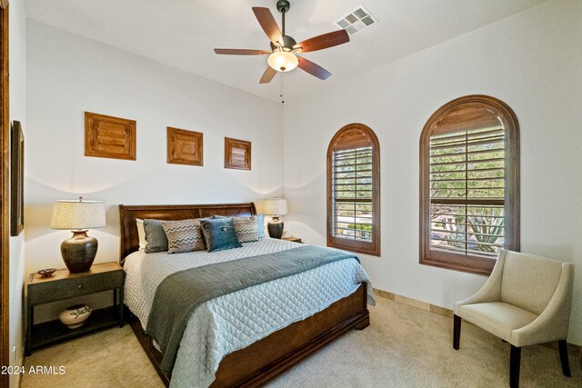 bedroom featuring ceiling fan and light colored carpet