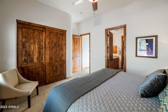 carpeted bedroom featuring ceiling fan and ensuite bathroom