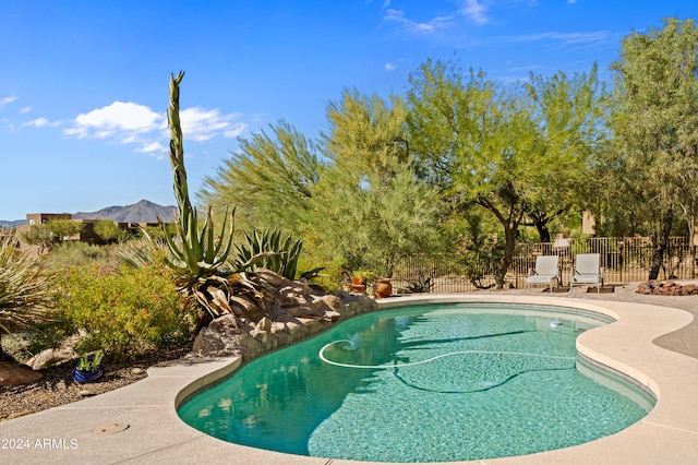 view of pool featuring a mountain view and a patio area