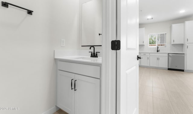 bathroom featuring vanity, backsplash, visible vents, and recessed lighting