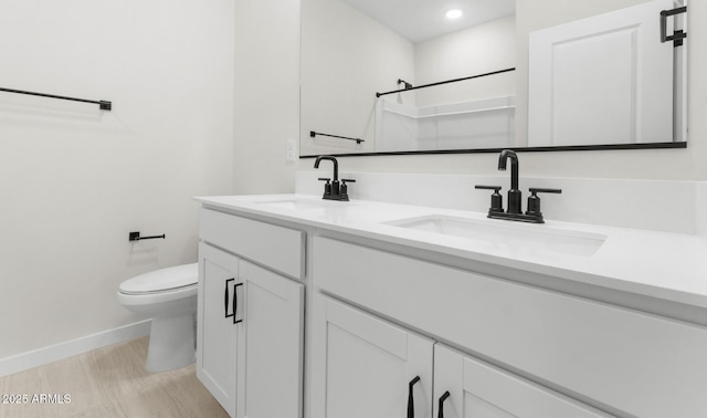 bathroom featuring baseboards, a shower, toilet, and a sink