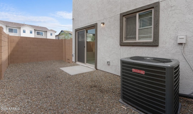 exterior space with cooling unit and fence