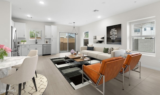 living room with baseboards, recessed lighting, and visible vents
