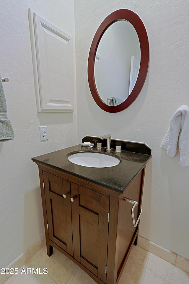 bathroom featuring tile patterned floors, baseboards, and vanity