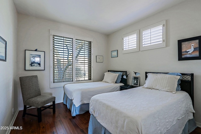 bedroom with baseboards and dark wood-style floors