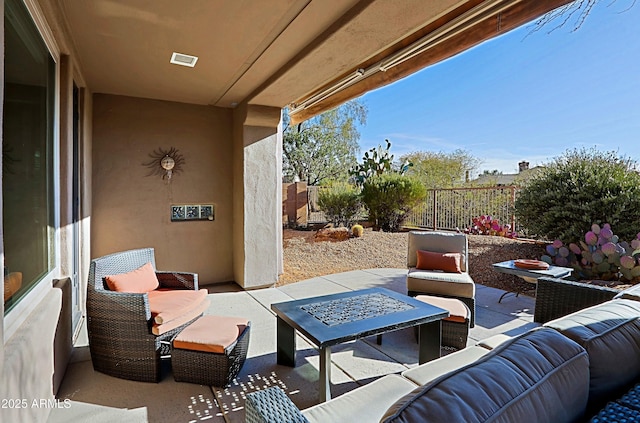 view of patio with visible vents, an outdoor hangout area, and fence