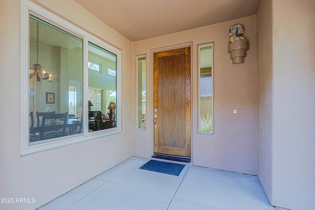 doorway to property featuring stucco siding