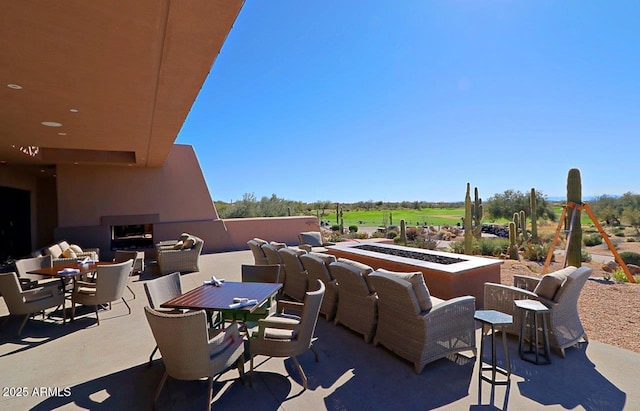 view of patio featuring outdoor dining space and an outdoor fire pit