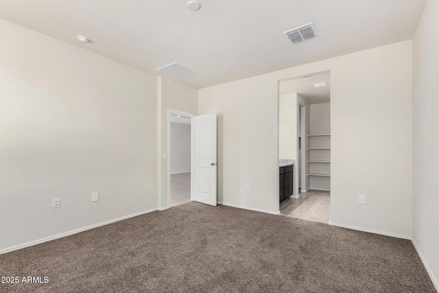 5240 E Gummite Dr, San Tan Valley, AZ 85143 - unfurnished bedroom featuring light colored carpet, baseboards, and ensuite bathroom