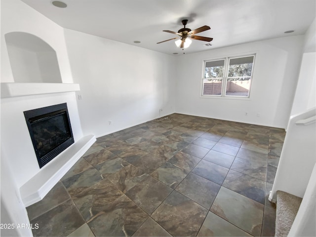 unfurnished living room featuring ceiling fan