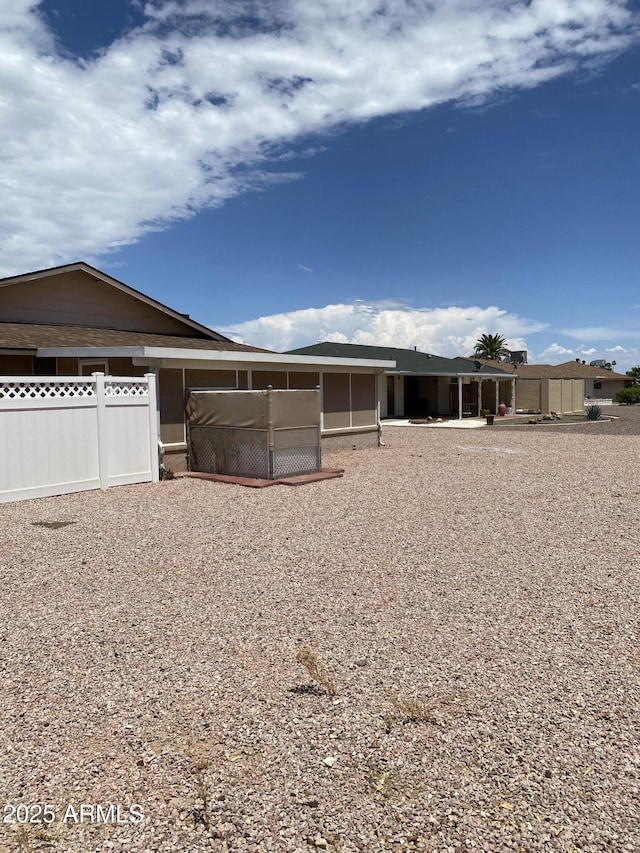 view of front of home featuring fence